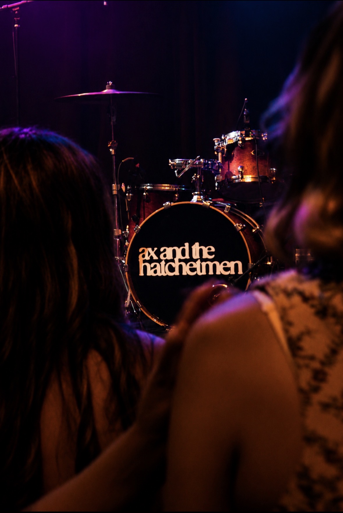 Drum kit framed by the concert audience