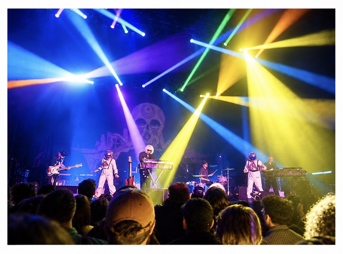 Full concert stage with crossing colorful beams of light